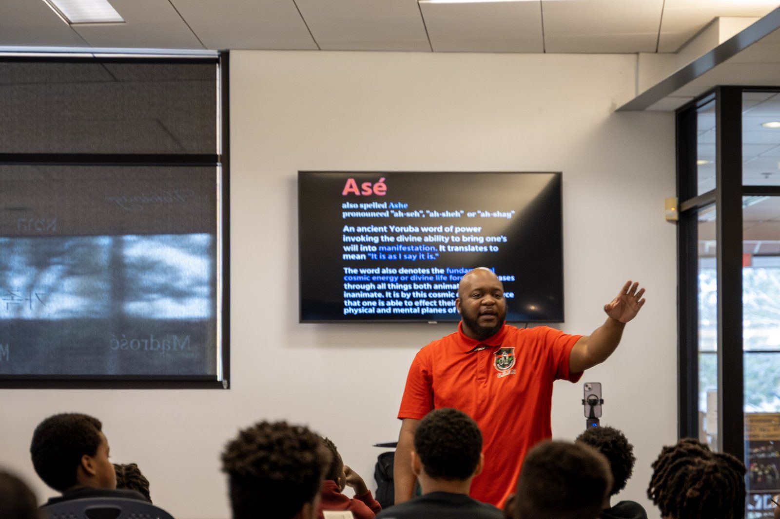 A facilitator presenting to mentees in a classroom