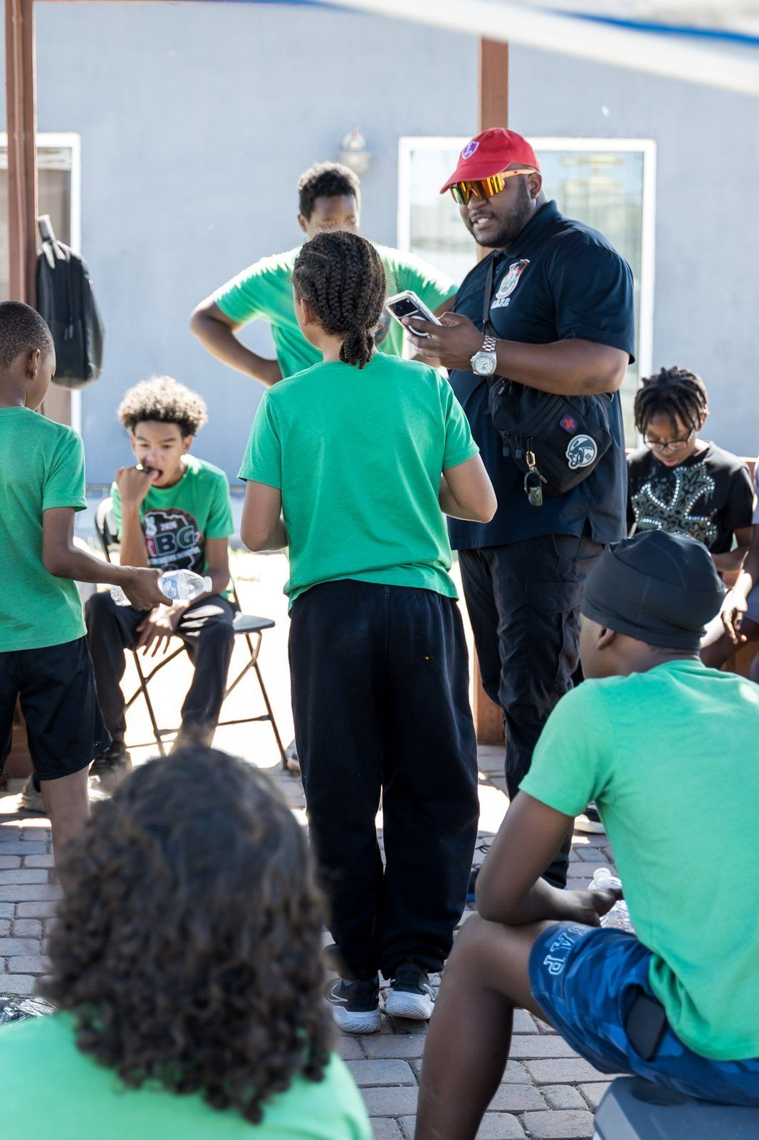 A mentor speaking with mentees seated in a circle
