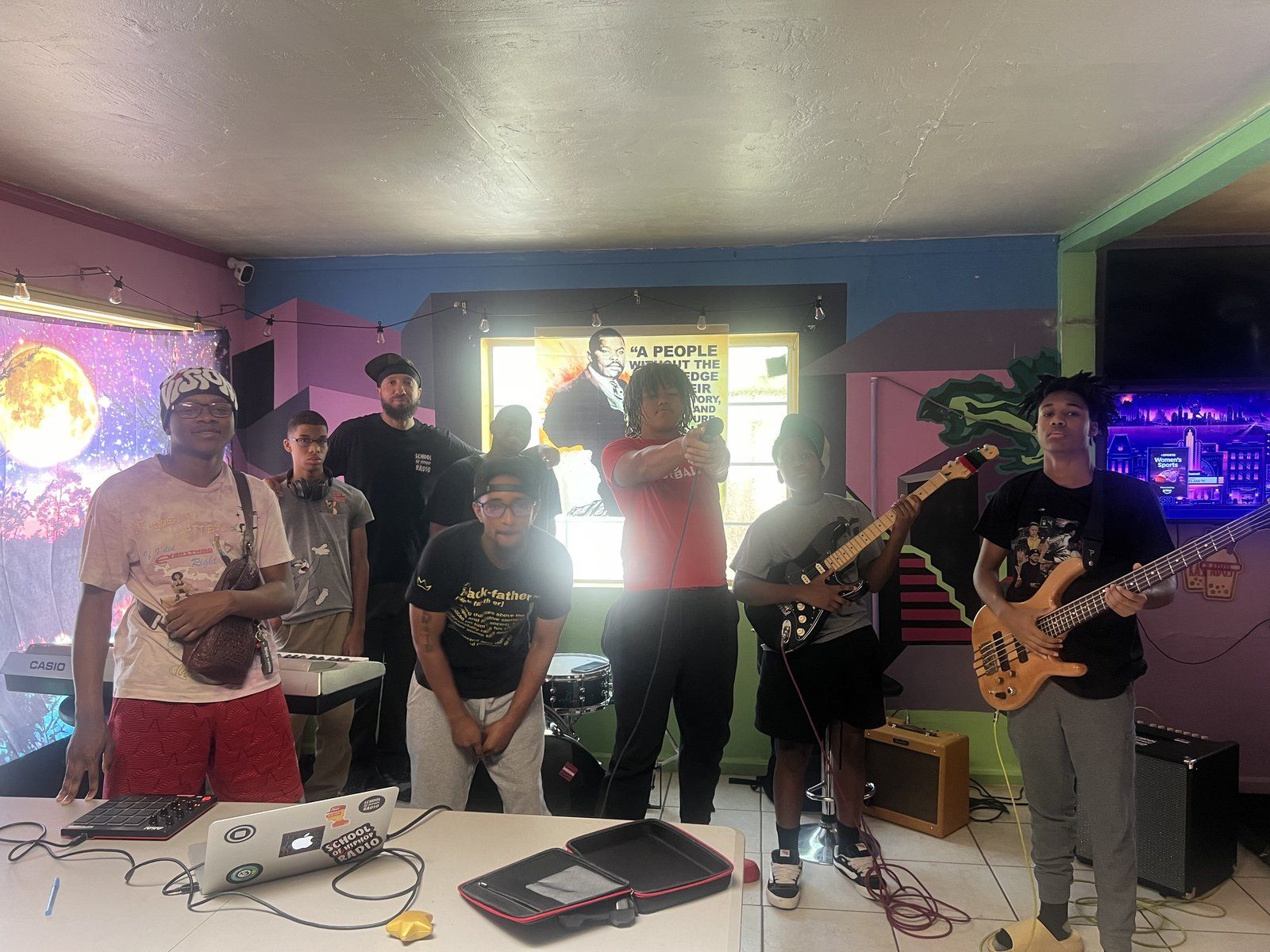 Mentees and mentors gathered in a music workshop space