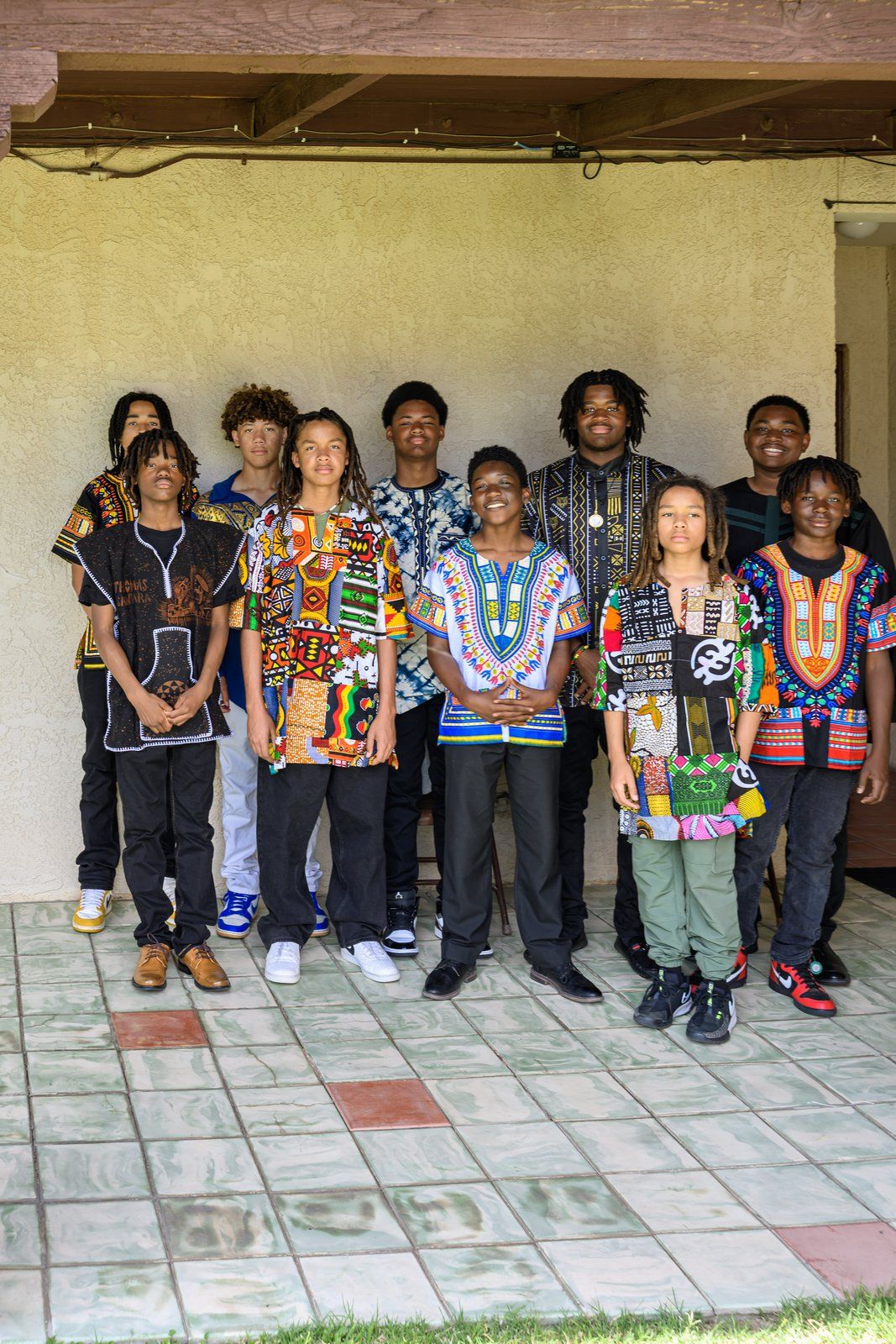 Mentees in dashikis and African print shirts standing together