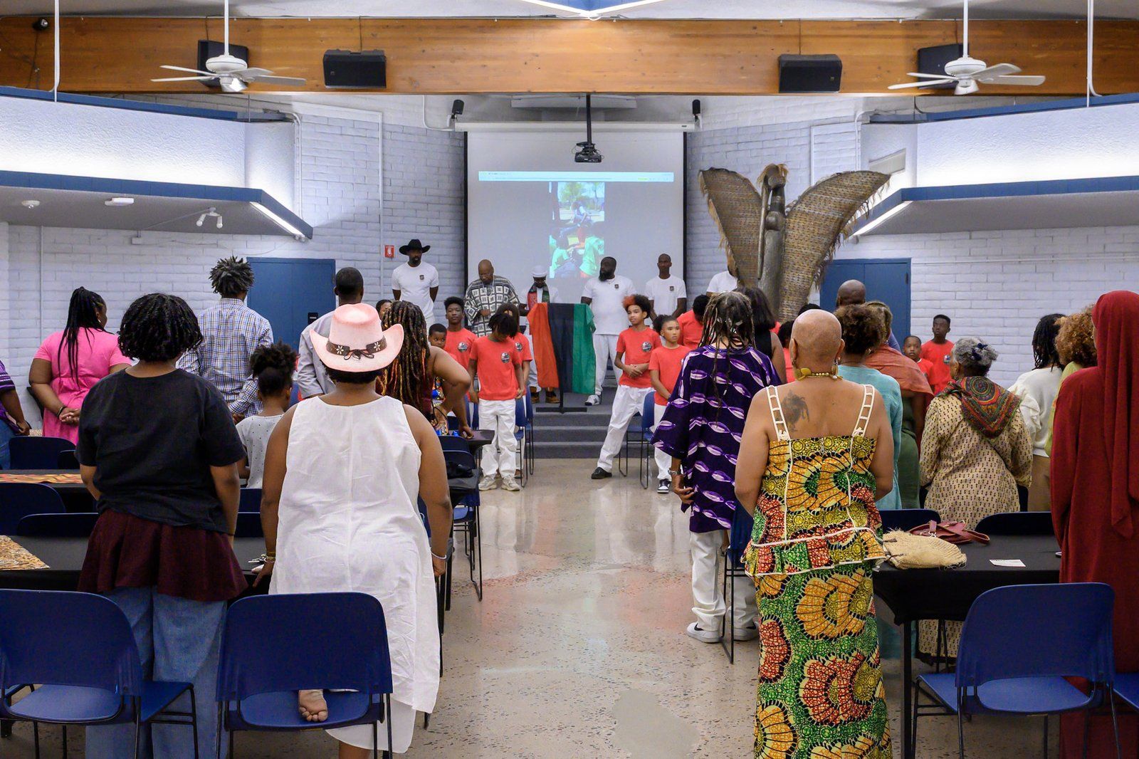 A community gathering in a hall during a cultural ceremony