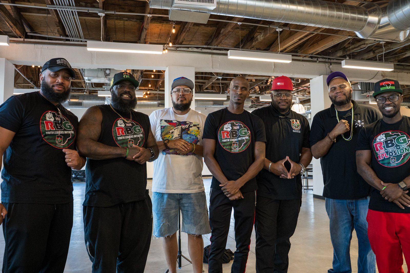 Fathers and mentors standing together at a community gathering