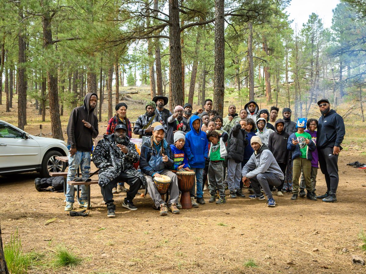 A full cohort gathered in the pines on an outdoor trip.